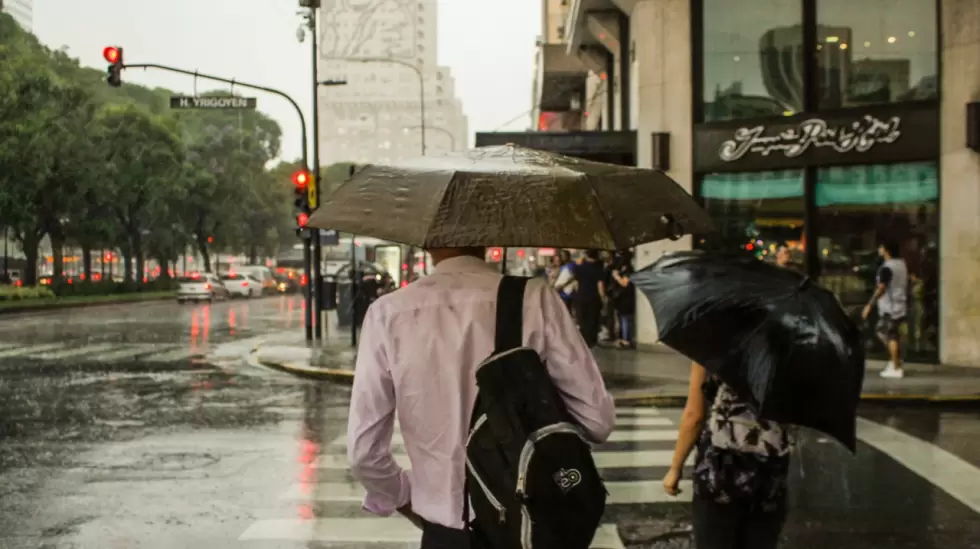 man-wearing-dress-shirt-holding-an-umbrella-2559961