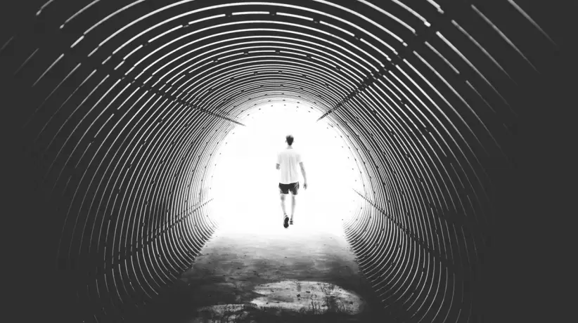 grayscale-photo-of-man-walking-in-hole-172738
