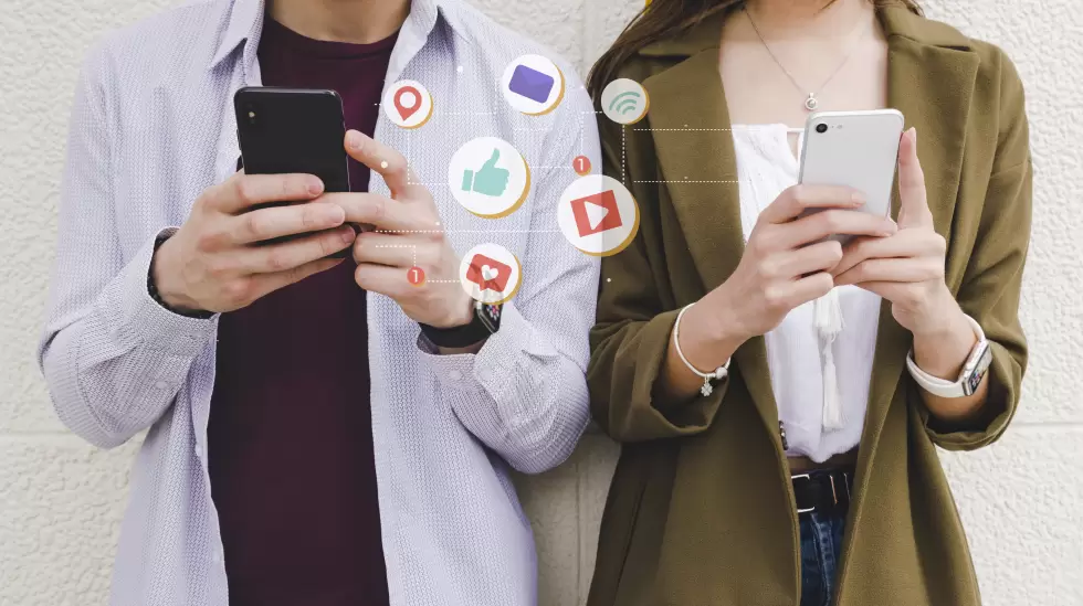 mobile-notification-icons-between-man-and-woman-using-cell-phone