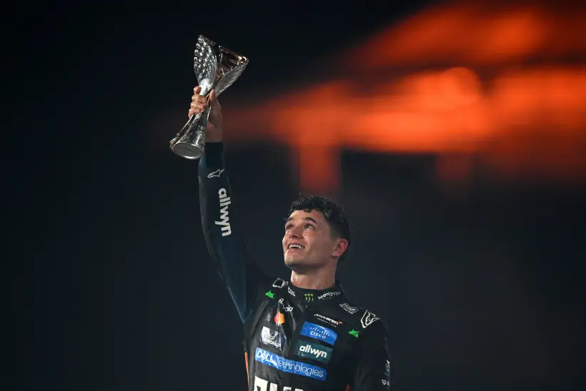 2025 F1 World Drivers Champion Lando Norris of Great Britain and McLaren celebrates on the podium during the F1 Grand Prix of Abu Dhabi