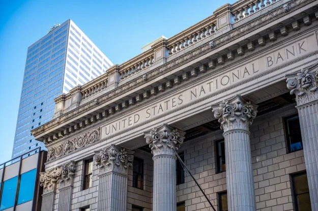 Vista cercana del edificio del Banco Nacional de los Estados Unidos con columnas clásicas y arquitectura.