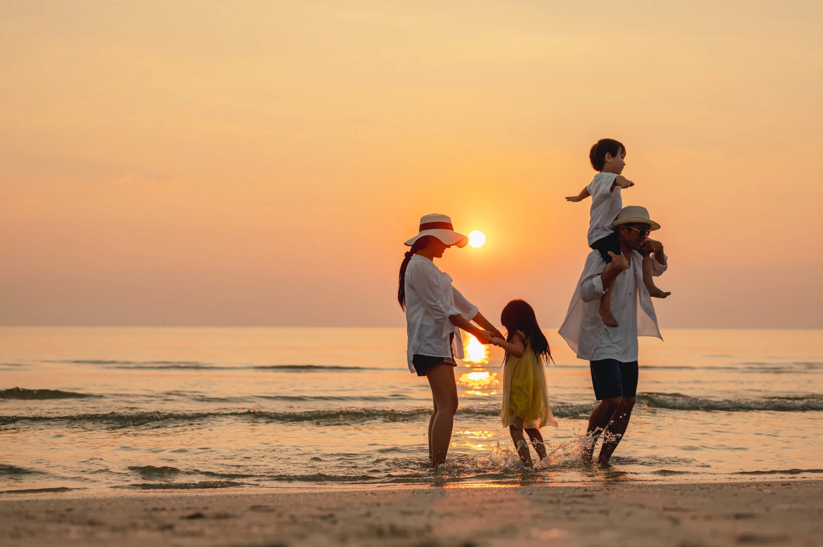 Happy asian family that enjoys beach activities during the summer holidays. parent and children enjoy the sunset sea on beach.Holiday travel concept,  - Nutthaseth Vanchaichana